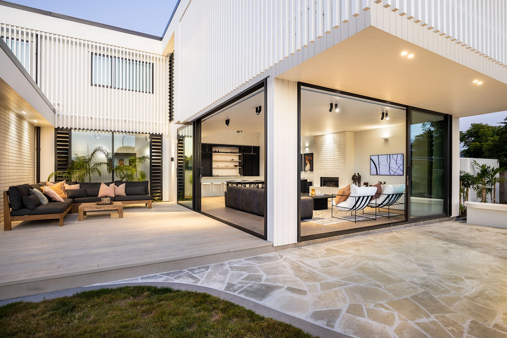 White house with big sliding doors and windows