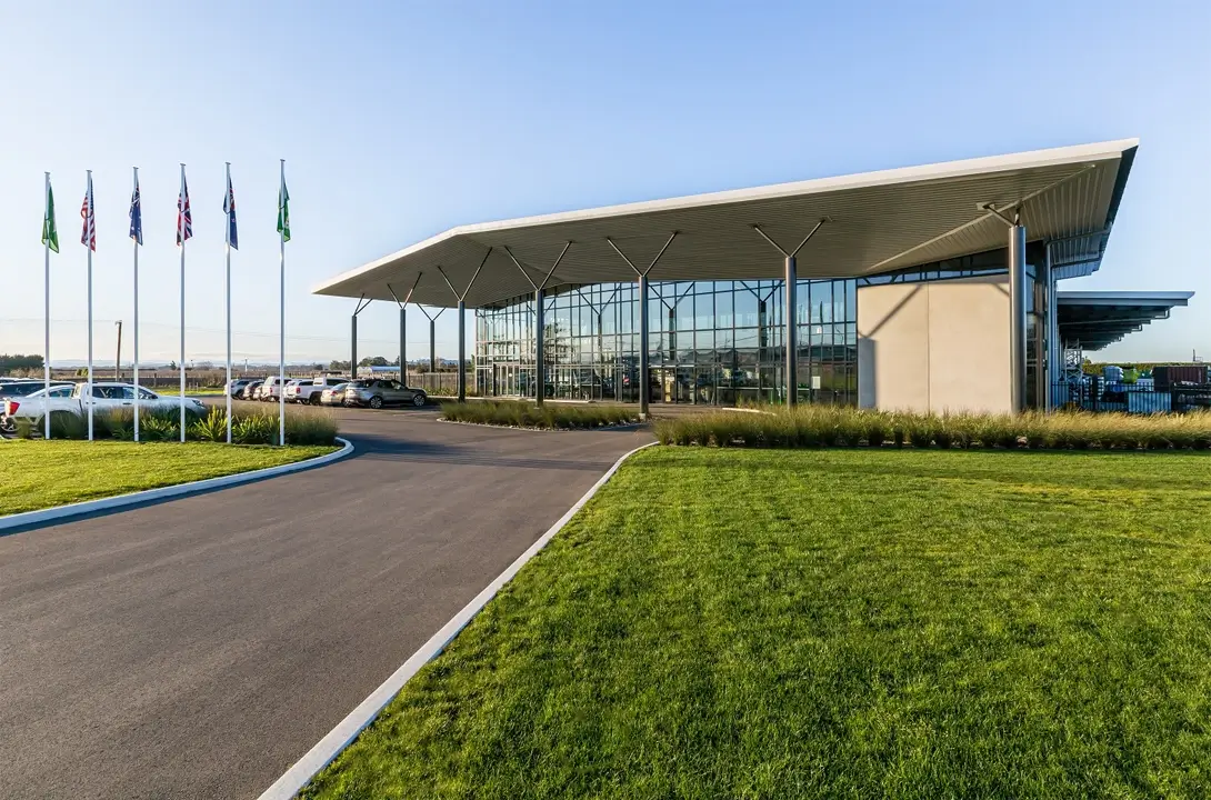 Concrete building with big windows with a carpark